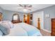 Spacious bedroom featuring a four-poster bed, ceiling fan, and a wooden dresser at 206 Kittys Ln, Erwin, NC 28339
