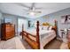 Cozy bedroom with a four-poster bed, ceiling fan, and light blue walls decorated with wall art at 206 Kittys Ln, Erwin, NC 28339
