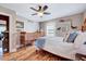 Inviting bedroom with wood floors, ceiling fan, and natural light from the window at 206 Kittys Ln, Erwin, NC 28339
