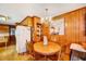 Charming breakfast nook with wood paneling, a round table, and a vintage chandelier at 206 Kittys Ln, Erwin, NC 28339