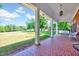 Spacious porch with classic white columns, tiled flooring and peaceful views of the yard at 206 Kittys Ln, Erwin, NC 28339