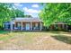 Charming brick home with a large, covered front porch and well-manicured lawn at 206 Kittys Ln, Erwin, NC 28339