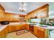 Spacious kitchen featuring wood cabinetry, a vintage stove, and laminate countertops at 206 Kittys Ln, Erwin, NC 28339