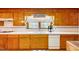 Charming kitchen offers a bright window with a view, white tile counters, and wood cabinets at 206 Kittys Ln, Erwin, NC 28339