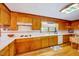 Traditional kitchen features warm wood cabinets, tile countertops, and vintage-style light fixture at 206 Kittys Ln, Erwin, NC 28339