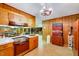 Retro kitchen with wood cabinets, vintage appliances, and open view to game and dining areas at 206 Kittys Ln, Erwin, NC 28339