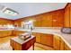 Bright and airy kitchen featuring warm wood cabinets, tile countertops and vintage island at 206 Kittys Ln, Erwin, NC 28339