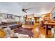 Open living area features hardwood floors, a brick fireplace, and seamless kitchen access at 206 Kittys Ln, Erwin, NC 28339
