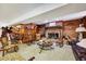 Rustic living room featuring a brick fireplace, wooden furniture, and unique decorations at 206 Kittys Ln, Erwin, NC 28339