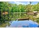 Scenic pond with a canoe, lush greenery, and reflections of the sky and trees, creating serene scenery at 206 Kittys Ln, Erwin, NC 28339