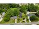 Aerial view showing the house, lush trees, and surrounding neighborhood at 209 E Winston St, Youngsville, NC 27596