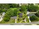 Aerial view of the home featuring mature landscaping, a quaint street, and a lush green lawn at 209 E Winston St, Youngsville, NC 27596