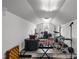 Converted attic space, ideal for hobbies or storage, illuminated by a central light fixture at 209 E Winston St, Youngsville, NC 27596