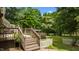 Inviting backyard features a deck with stairs, lush greenery, and a charming white picket fence at 209 E Winston St, Youngsville, NC 27596