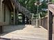 Wooden deck with access to upper level, features a patio heater and overlooks a lush backyard at 209 E Winston St, Youngsville, NC 27596