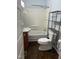Bathroom with a shower and tub combo and dark wood style flooring at 209 E Winston St, Youngsville, NC 27596