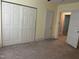 Bedroom featuring neutral carpet, closet space, and an open door to another room at 209 E Winston St, Youngsville, NC 27596