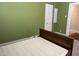 Olive-painted bedroom with a classic bed frame and natural light, offering a cozy atmosphere at 209 E Winston St, Youngsville, NC 27596