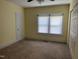 Bedroom features neutral carpet, ceiling fan, and closet space at 209 E Winston St, Youngsville, NC 27596
