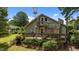 Charming home exterior with a spacious deck, inviting stairs, and lush landscaping at 209 E Winston St, Youngsville, NC 27596
