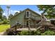Charming home exterior with a spacious deck, inviting stairs, and lush landscaping at 209 E Winston St, Youngsville, NC 27596