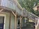 Exterior view of a home with a wooden deck and stairs, highlighting outdoor living space at 209 E Winston St, Youngsville, NC 27596