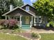 Charming home with a quaint porch, yellow door, and well-maintained front yard at 209 E Winston St, Youngsville, NC 27596