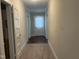 Hallway leading to a rear door, with carpeted floors and several rooms leading off it at 209 E Winston St, Youngsville, NC 27596