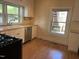 Bright kitchen features a stainless steel dishwasher and a double bowl sink with updated faucet at 209 E Winston St, Youngsville, NC 27596