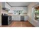 Bright kitchen with white cabinets, stainless appliances, and a window offering lots of natural light at 209 E Winston St, Youngsville, NC 27596