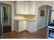 Kitchen showcases white cabinetry and laminate countertops, offering ample storage and workspace at 209 E Winston St, Youngsville, NC 27596