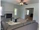 Spacious living room featuring a fireplace and view of a separate den with french doors at 209 E Winston St, Youngsville, NC 27596