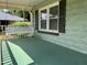 Inviting porch with a swing, perfect for relaxing and enjoying the outdoors at 209 E Winston St, Youngsville, NC 27596