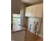 Utility room with upper cabinets, and a large window at 209 E Winston St, Youngsville, NC 27596