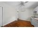 Open kitchen and dining area with hardwood floors, white appliances, and a ceiling fan at 212 Northwood Cir, Durham, NC 27701