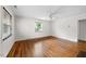 Bright living room featuring beautiful hardwood floors, natural light, and a ceiling fan at 212 Northwood Cir, Durham, NC 27701