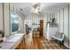 Cozy dining area with wooden floors, striped wallpaper and a view to the next room at 214 Northwood Cir, Durham, NC 27701