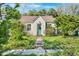 Charming bungalow featuring a quaint front entrance, complemented by lush green surroundings at 214 Northwood Cir, Durham, NC 27701