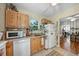Bright kitchen with stainless steel appliances, light wood cabinets and view of dining area at 214 Northwood Cir, Durham, NC 27701
