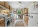 Well-lit kitchen with white appliances, light wood cabinets and checkered floor mat at 214 Northwood Cir, Durham, NC 27701
