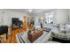 This home includes a living room with hardwood flooring and a comfortable sectional couch at 214 Northwood Cir, Durham, NC 27701