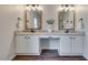 Bathroom featuring dual sinks, granite countertops, and decorative mirrors at 215 Graduate Ct, Durham, NC 27713