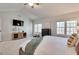Bright bedroom with TV, dresser, and plenty of natural light at 215 Graduate Ct, Durham, NC 27713