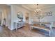 Bright dining room features a modern chandelier and stylish decor, and wood flooring at 215 Graduate Ct, Durham, NC 27713