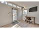 Bright outbuilding interior includes wood floors, a desk, a chair, and a TV at 215 Graduate Ct, Durham, NC 27713