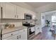 Bright kitchen with stainless steel appliances and granite countertops, seamlessly connects to the dining area at 215 Graduate Ct, Durham, NC 27713