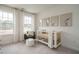 Cozy Bedroom with soft colors, a crib, comfortable chair, and natural light at 2301 Bay Minette Sta # 538, Apex, NC 27502