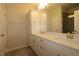 Bathroom with double sink vanity, mirror, and shower with tiled walls at 2323 Hunter Woods Dr # 566, Apex, NC 27502