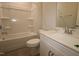 Bathroom with a tub, tiled floors, toilet and sink with a white cabinet at 2323 Hunter Woods Dr # 566, Apex, NC 27502