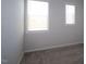This carpeted bedroom is illuminated by natural light through two windows at 2323 Hunter Woods Dr # 566, Apex, NC 27502